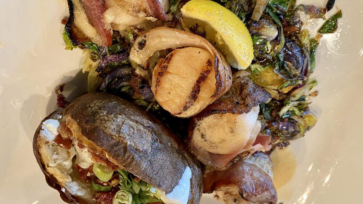 Bacon-wrapped scallops, Brussels sprouts and a baked potato at Blu Crab.