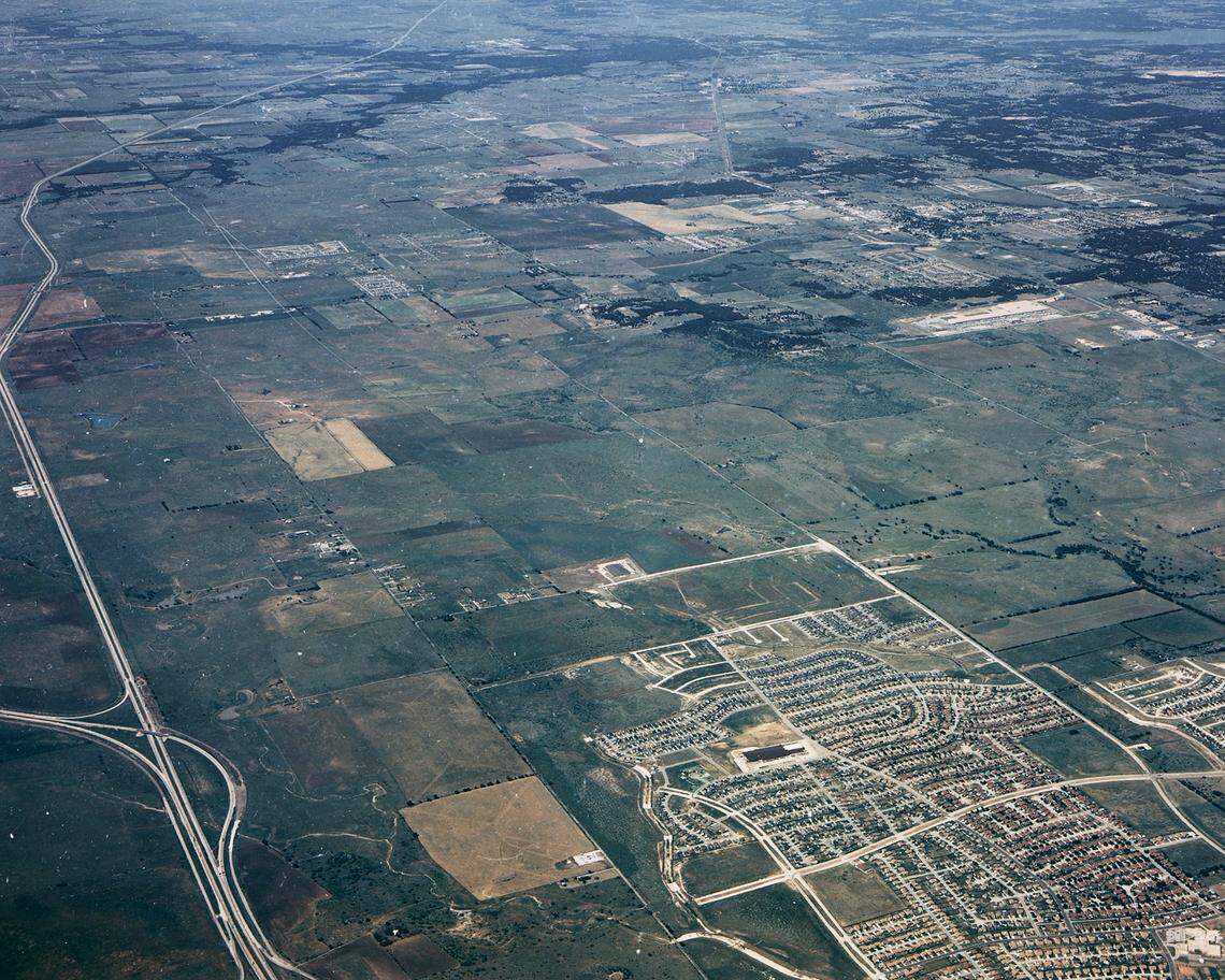 1988: This photo shows the undeveloped east side of Interstate 35W before North Tarrant Parkway and Heritage Trace Boulevard were built. The U.S. 287 ramps are seen to the lower left. The neighborhood shown is Summerfields.