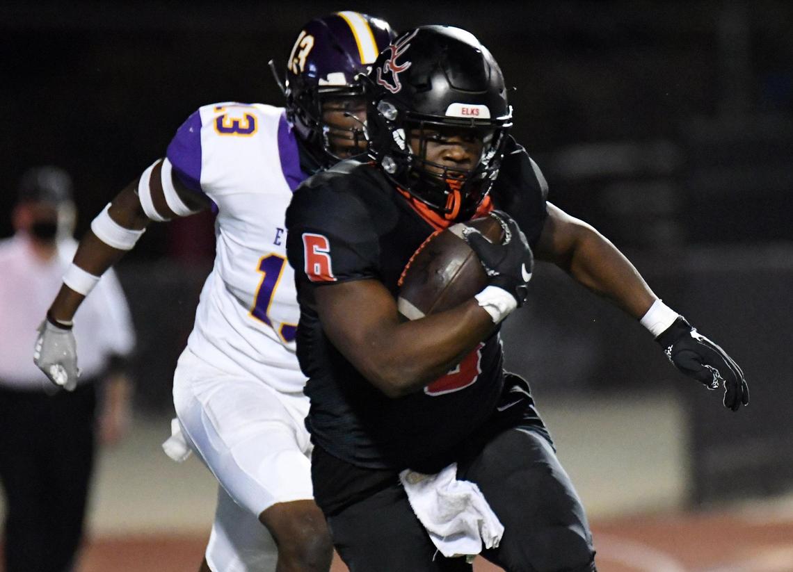 Burleson’s Jarrett Austin, front, races away from Everman’s Bradley Langston out of the backfield for a first down in the first quarter of their Division 2 District 5-5A football game Thursday, November12, 2020 at Burleson ISD Stadium in Burleson, Texas. Special/Bob Haynes