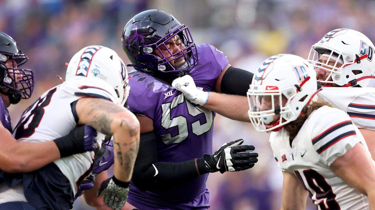 TCU left tackle Obinna Eze, center, blocks Duquesne defensive lineman Jack Dawson (50) during TCU’s season opener on Sept. 4. Eze, a transfer from Memphis, has started every game for the Horned Frogs this season.