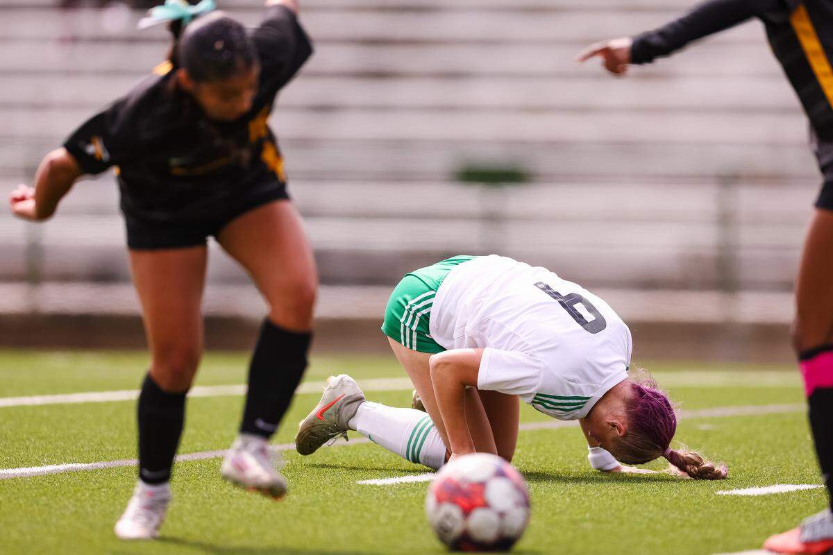 Southlake Carroll striker Caroline Holcombe (9) holds her leg in agony after colliding with a Forney defender in a UIL Class 6A Division 2 girls soccer state semifinal on Saturday, April 4, 2026, at Memorial Stadium in Mesquite, Texas.