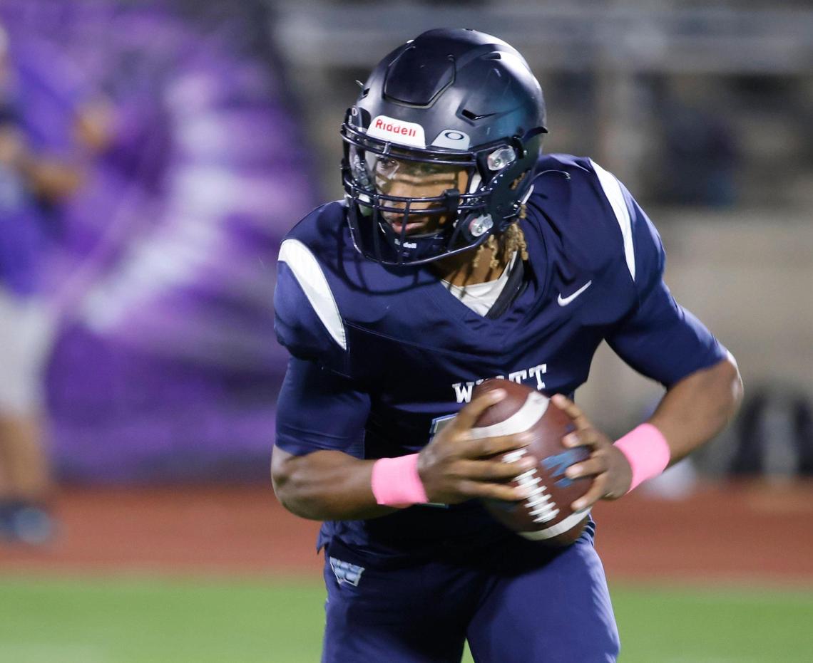 Wyatt quarterback Jorvorskie Lane (13) rolls out to the left during a District 4-5A Division 1 football game at Herman Clark Stadium in Fort Worth, Texas, Thursday, Oct. 24, 2024.
