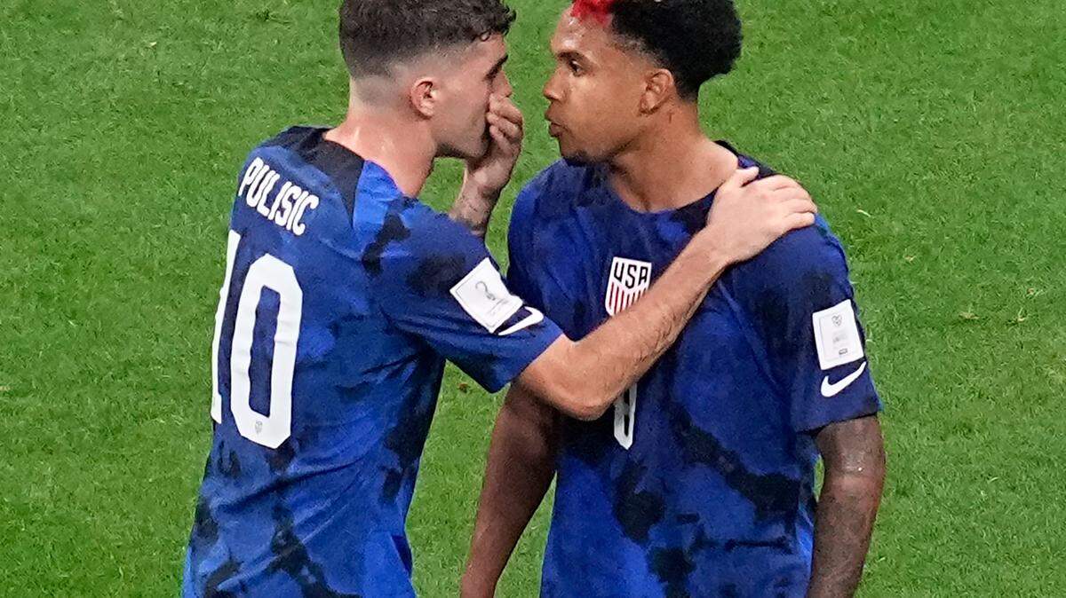 Christian Pulisic of the United States, left, speaks with teammate Weston McKennie during the World Cup group B soccer match between England and The United States, at the Al Bayt Stadium in Al Khor, Qatar, Friday, Nov. 25, 2022. (AP Photo/Ebrahim Noroozi)