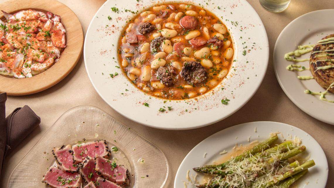 Plates of Si Tapas dishes which are pulpo a la gallega, fabada asturiana, atun a la plancha and asparagus.