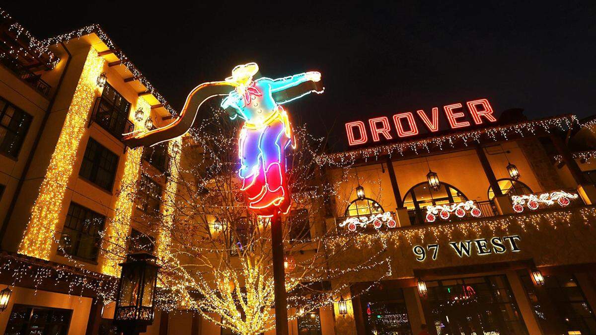 Neon sign of a drover with a whip in front of Hotel Drover