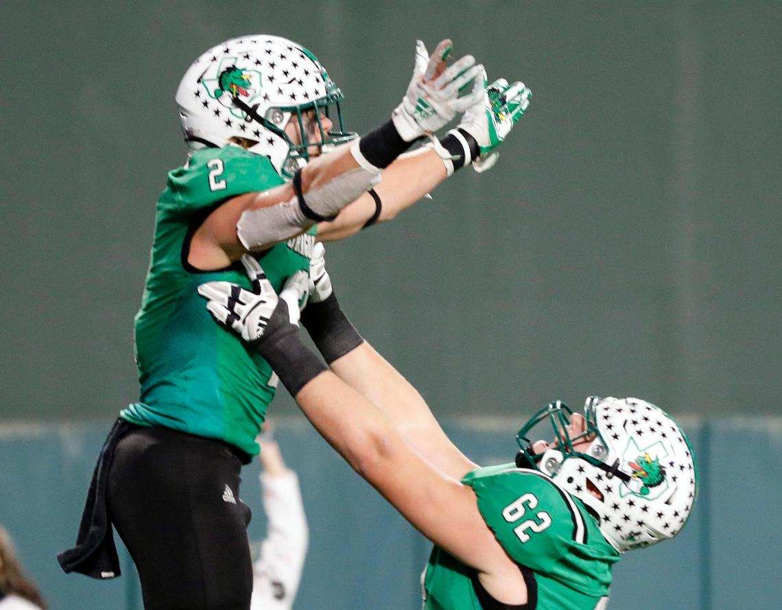 Southlake Carroll running back Owen Allen (2) is lifted up by offensive lineman Andrew Cunningham (62) after scoring the winning touchdown in the second half of Class 6A D2 regional semi-finals football game at Choctaw Stadium in Arlington, Texas, Friday, Nov. 25, 2022. Carroll defeatrd McKinney 42-35 to move on to the regional finals. (Special to the Star-Telegram Bob Booth)