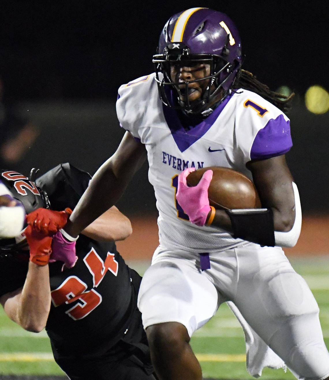 Everman quarterback Juan Davis stiff arms his way past Burleson’s Kyndall Cassidy for positive yards in the first quarter of their Division 2 District 5-5A football game Thursday, November12, 2020 at Burleson ISD Stadium in Burleson, Texas. Special/Bob Haynes