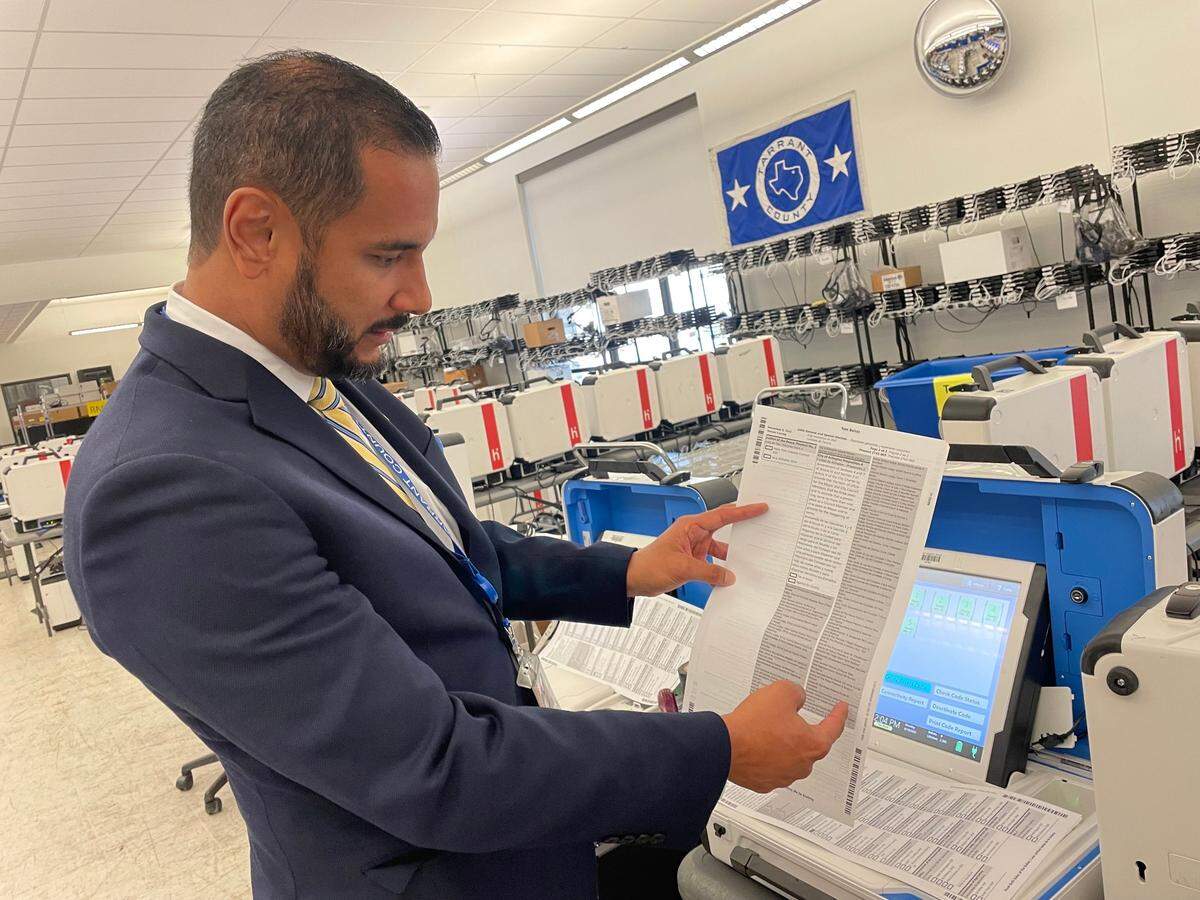 Tarrant County Election Administrator Heider Garcia points to a test ballot for the November election on Sept. 19, 2022.