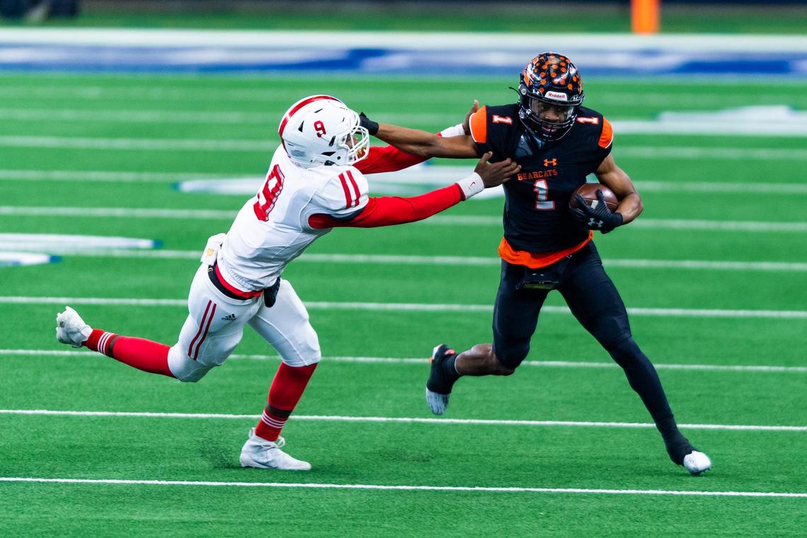 JoJo Earle (1) stiff arms Sir Hill (9) after catching a pass during the 2nd quarter of the 5A Division 2 state championship game at AT&T Stadium in Arlington between Aledo and Crosby on January 15th, 2020.