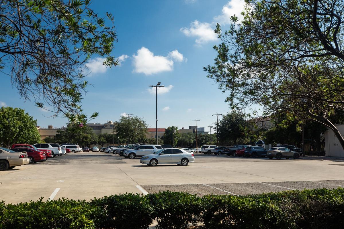 A parking lot by the TCU campus store on Friday, July 19, 2024, in Fort Worth. TCU is looking at developing several blocks along West Berry Street.