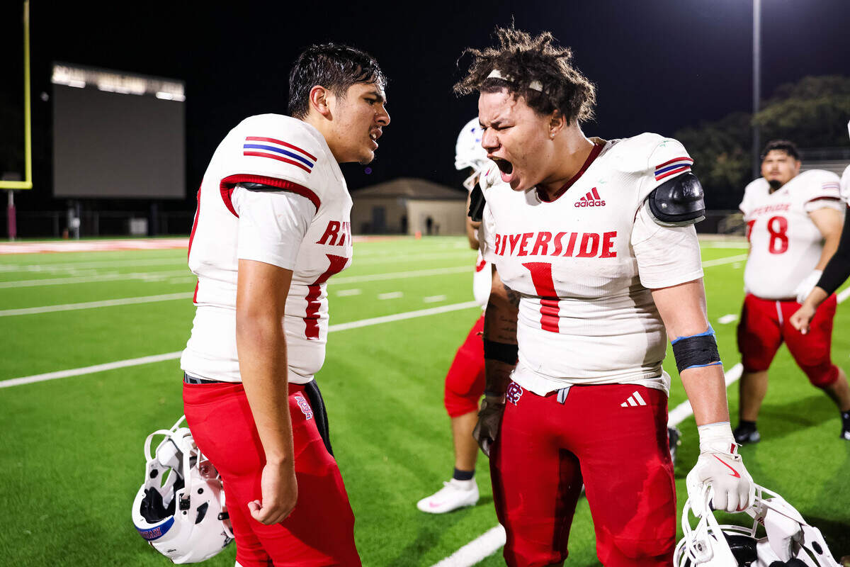 Fort Worth Carter-Riverside quarterback Jacob Galindo (left) and running back Deandre Fields celebrate after clinching a playoff berth with a 36-34 win over Fort Worth Western Hills on Friday at Scarborough-Handley Field.