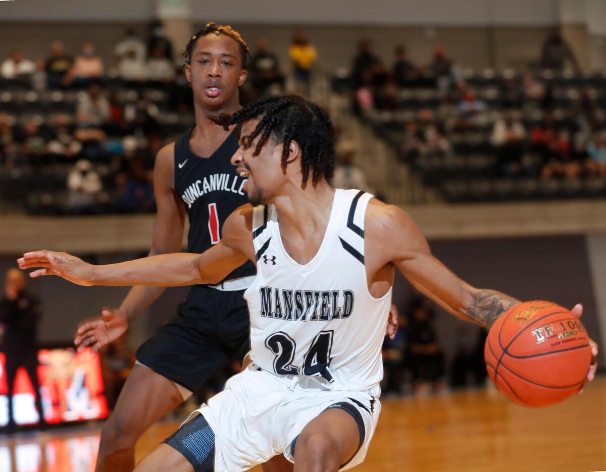 Mansfield guard Drew Crippen (24) passes down the baselines away from Duncanville forward Ron Holland (1) during the second half of a 6A Region 1 quarterfinal basketball game at Arlington ISD Athletics Complex in Arlington, Texas, Saturday, Feb. 27, 2021. Duncanville defeated Mansfield 73-53. (Special to the Star-Telegram Bob Booth)