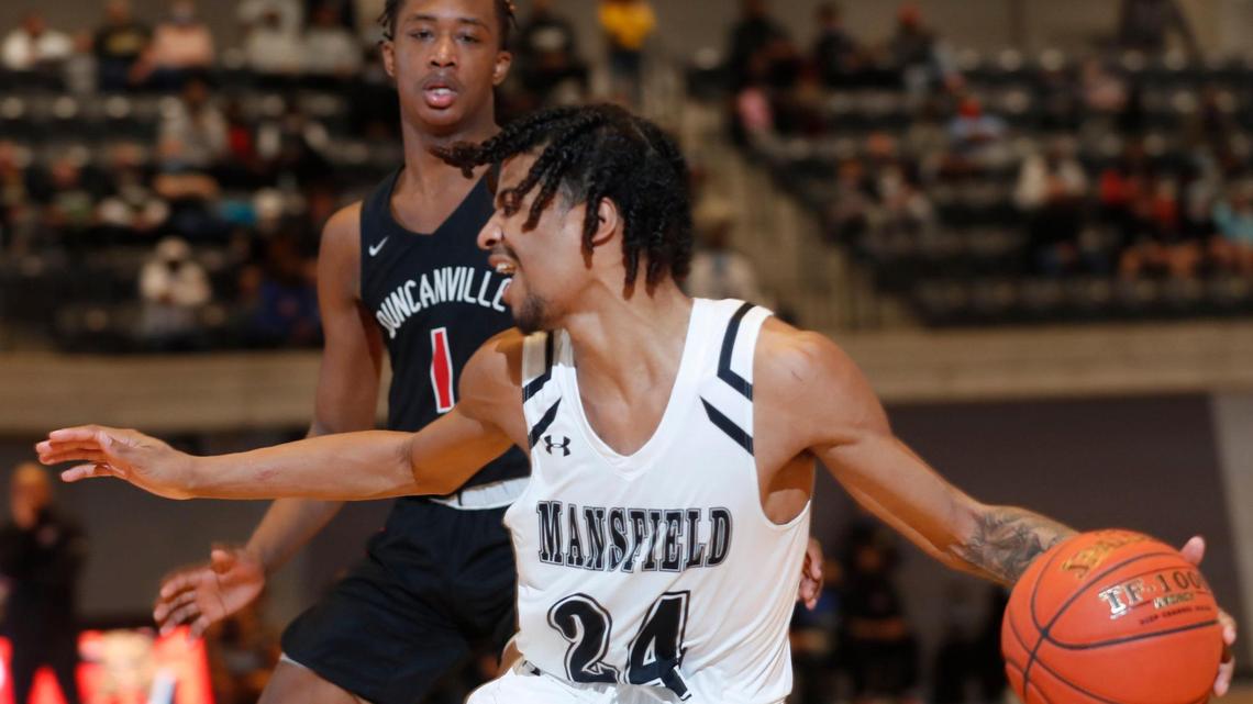 Mansfield guard Drew Crippen (24) passes down the baselines away from Duncanville forward Ron Holland (1) during the second half of a 6A Region 1 quarterfinal basketball game at Arlington ISD Athletics Complex in Arlington, Texas, Saturday, Feb. 27, 2021. Duncanville defeated Mansfield 73-53. (Special to the Star-Telegram Bob Booth)