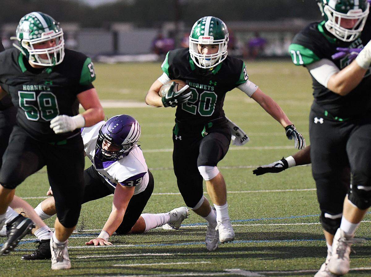 Azle’s Billy Heath, center, takes the ball up the middle for a touchdown and a 13-7 lead over Crowley during the first quarter of Friday’s football game at Hornet Stadium in Azle, Texas.