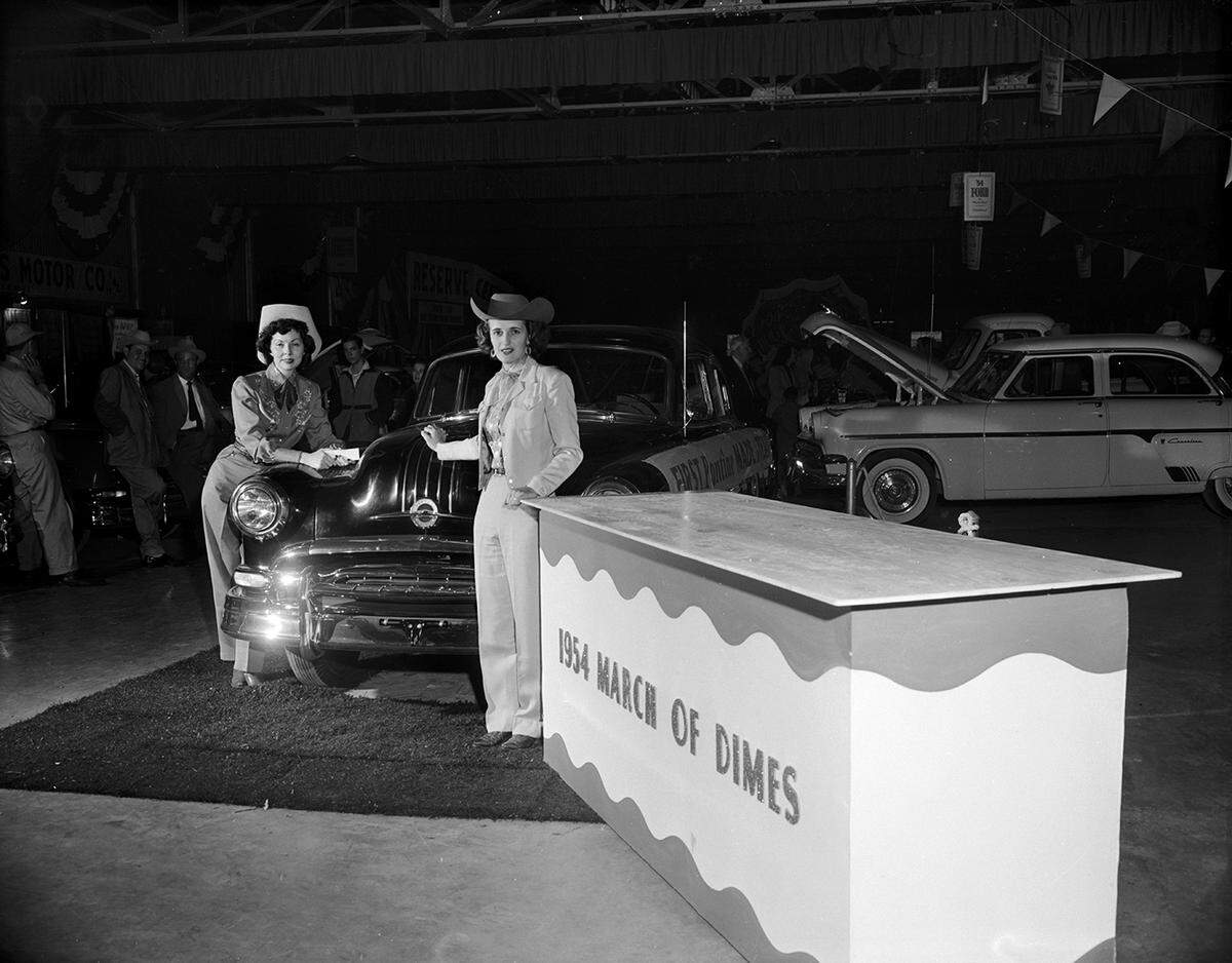 Jan. 30, 1954: This 1954 Pontiac, the first automobile to be produced in the General Motors assembly plant at Arlington, is to be given away by the Tarrant County chapter of the National Foundation for Infantile Paralysis, as part of the March of Dimes. The Pontiac was purchased by the Amon G. Carter Foundation from General Motors and given to the polio chapter. Admiring the car at the March of Dimes booth at Southwestern Exposition and Fat Stock Show are Mrs. Helen Johnson, left of 1612 Coleman, and Mrs. Sue Payne of 4836 Old Mansfield Road.