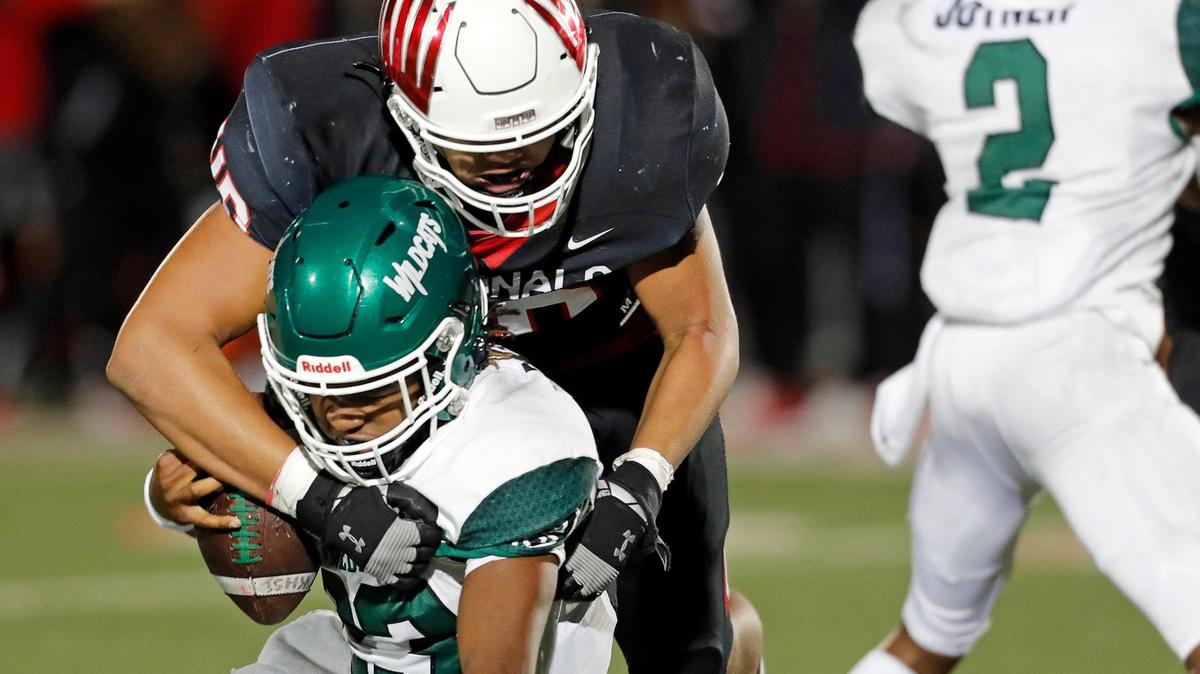 Melissa defensive lineman Nigel Smith (40) sacks Kennedale quarterback Jeremiah Myers (23) during a high school Conference 4A Division 1 area round football playoff game at Mustang Panther Stadium in Grapevine, Texas, Friday, Nov. 20, 2020. Melissa led Kennedale 26-10 at the half. (Special to the Star-Telegram Bob Booth)