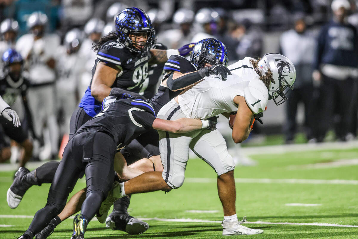 Denton Guyer’s Kaedyn Cobbs (1) gets tackled by a trio of Byron Nelson defenders in a Class 6A Division II regional semifinal Friday.