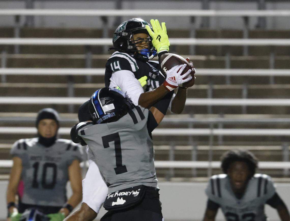 Lake Ridge wide receiver Jayden Evans (14) almost came down with the catch defended by North Crowley safety Elijajuan Houston (7) during the first half of a UIL football game between North Crowley and Lake Ridge at Vernon Newsom Stadium in Mansfield, Texas, Thursday, October 9, 2025.