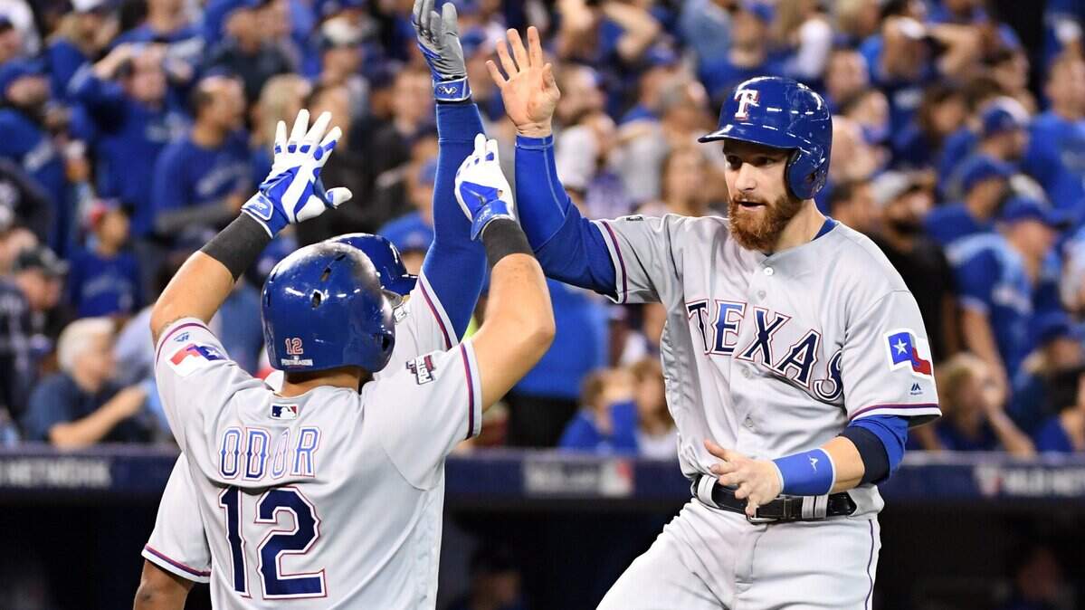 Oct 9, 2016; Toronto, Ontario, CAN; Texas Rangers catcher Jonathan Lucroy (right) celebrates with second baseman Rougned Odor (12) after scoring a run against the Toronto Blue Jays in the 6th inning during game three of the 2016 ALDS playoff baseball series at Rogers Centre. Mandatory Credit: Nick Turchiaro-USA TODAY Sports