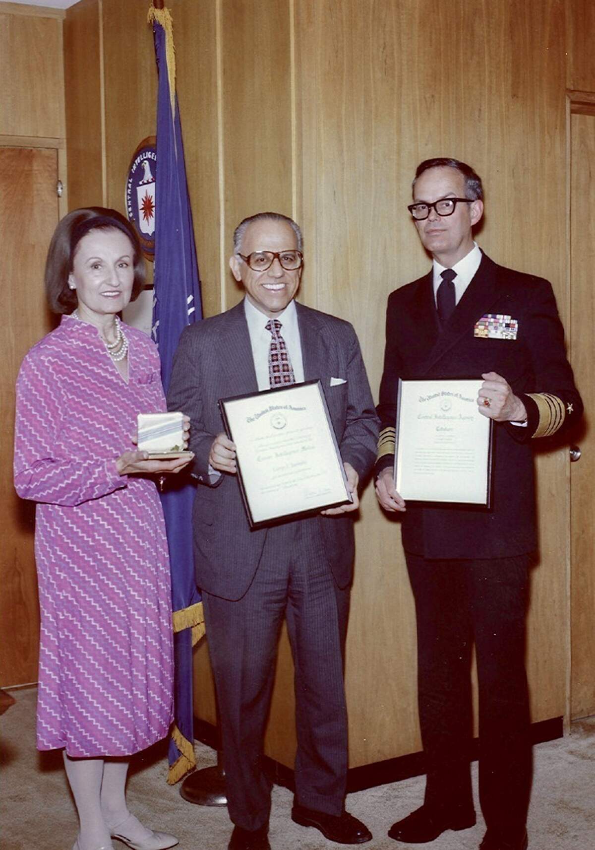 George Joannides, center, a CIA case officer, receives a career award from Adm. Bobby Inman, then deputy director of the CIA, in a CIA photo on July 15, 1981.