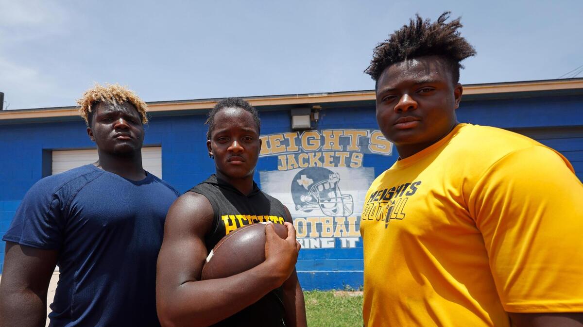 Arlington Heights head football coach Curtis James sons defensive end Caynan, running back Carson and defensive end Carter at the schools football field in Fort Worth, Texas, Thursday July 17, 2025.