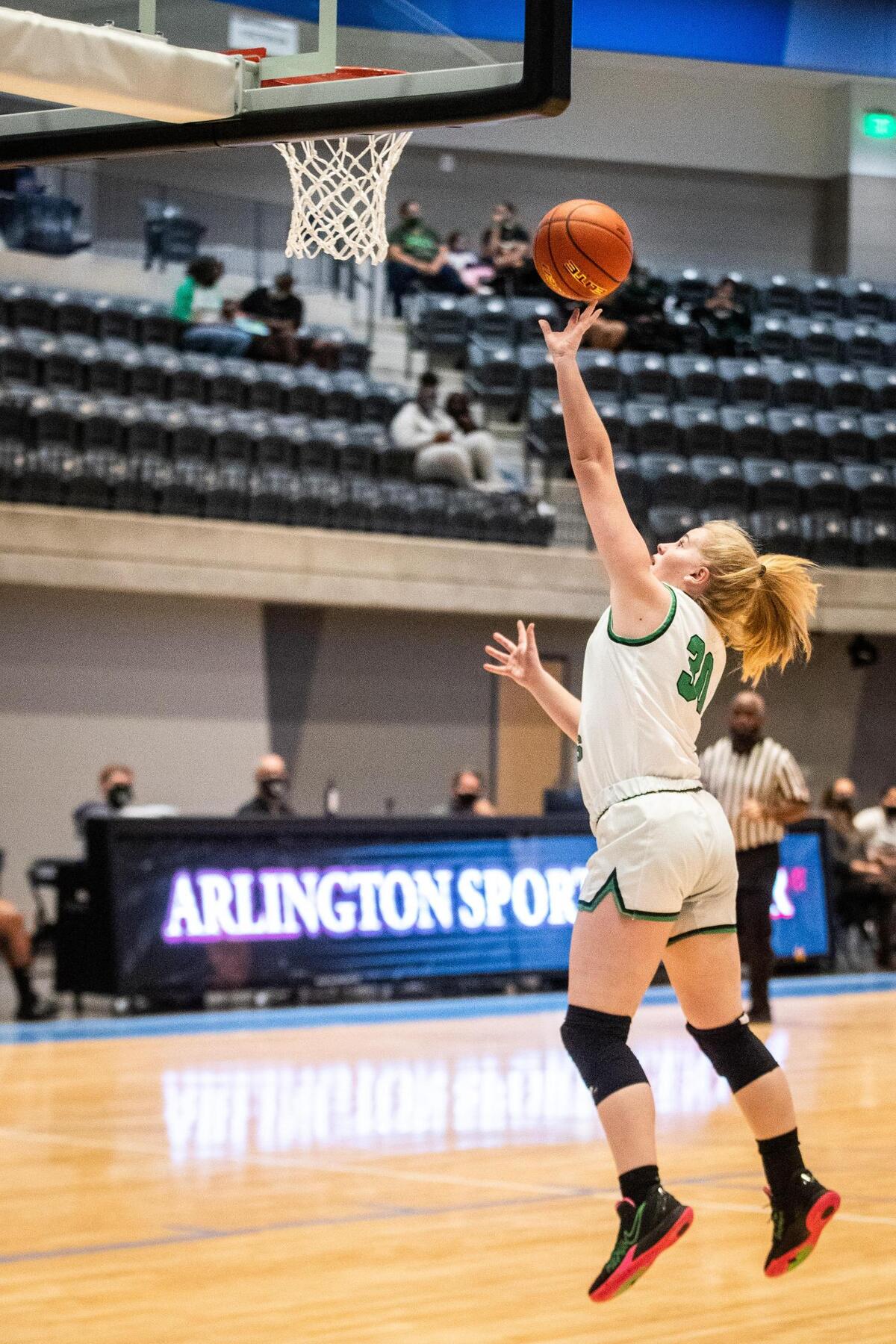 Arlington’s Landry Mills jumps up for a layup during the game against YWLA Tuesday, Nov. 10, 2020, at the new Arlington ISD Athletics Center.