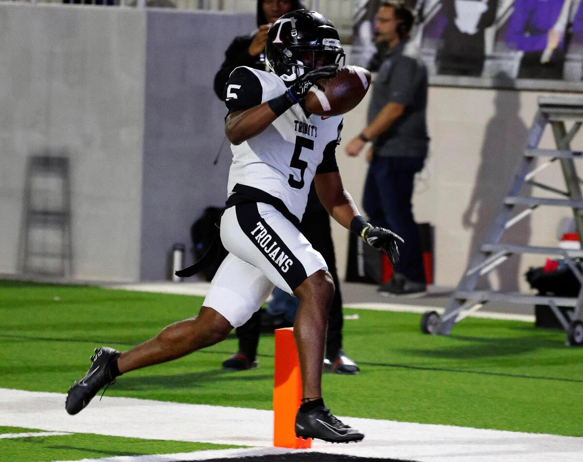 Trinity running back Ethan Wright (5) crosses the goal line for six in the first half of a UIL high school football game at Crowley ISD Multi-Purpose Stadium in Crowley, Texas, Friday, Oct. 20, 2023. Trinity Trojans led the Crowley Eagles 35-27 at the half.