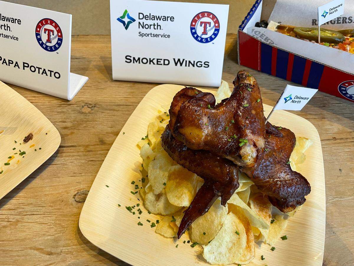 Smoked wings are served with Sweet Baby Ray’s barbecue sauce.