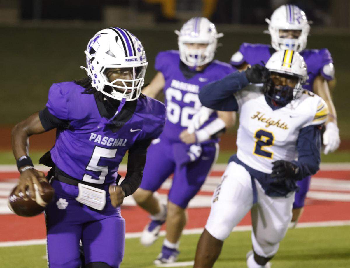 Paschal quarterback Jashaun Thomas (5) scrambles out of the backfield during the first half of a UIL football game between Arlington Heights and Paschal at Farrington Field in Fort Worth, Texas, Friday Nov. 07, 2025.