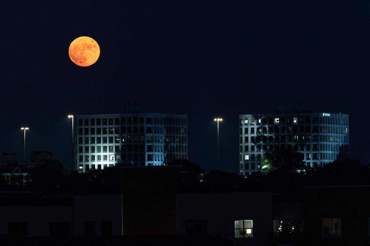 The Super Blue Moon rises over the Summit Office Park Plaza near downtown Fort Worth on Wednesday, Aug. 30, 2023.