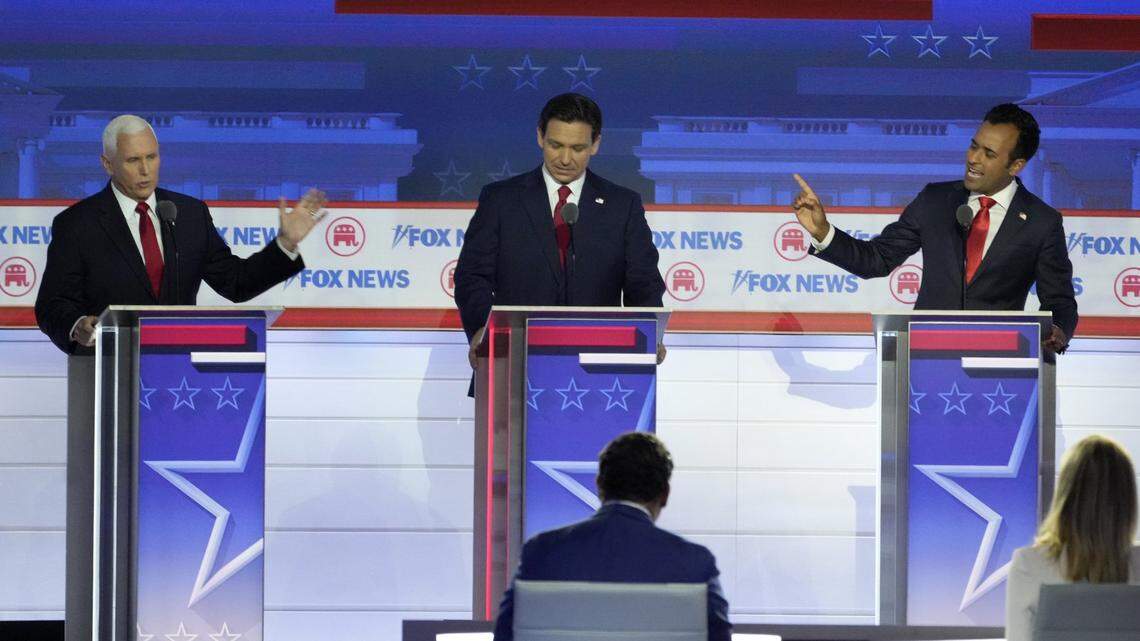 Aug 23, 2023; Milwaukee, WI, USA; Republican presidential candidate former Vice President Mike Pence (left) and Republican presidential candidate Biotech entrepreneur Vivek Ramaswamy argue a topic as Republican presidential candidate Florida governor Ron DeSantis listens in at Fiserv Forum during the first 2023 Republican presidential debate. Mandatory Credit: Mike De Sisti-USA TODAY NETWORK