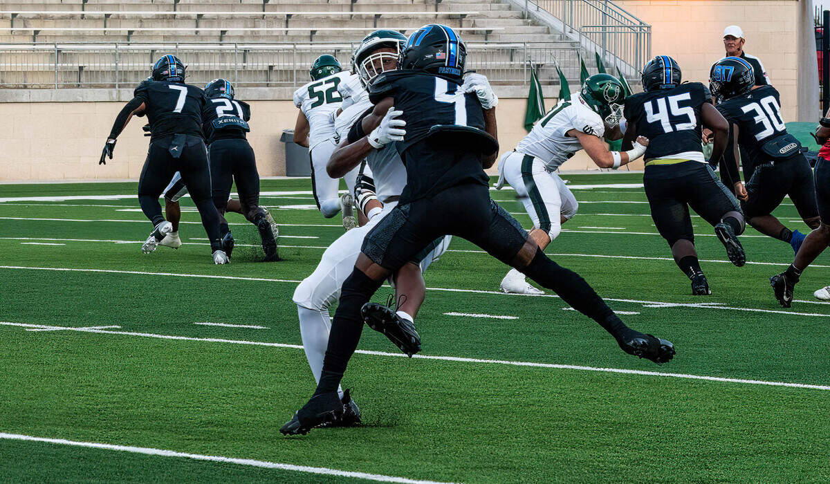 North Crowley’s David Moore (4) tangles with an Arlington Colt blocker as the Panthers pursue on defense on Friday September 1, 2023 at Crowley IDS Stadium in Fort Worth, Texas.