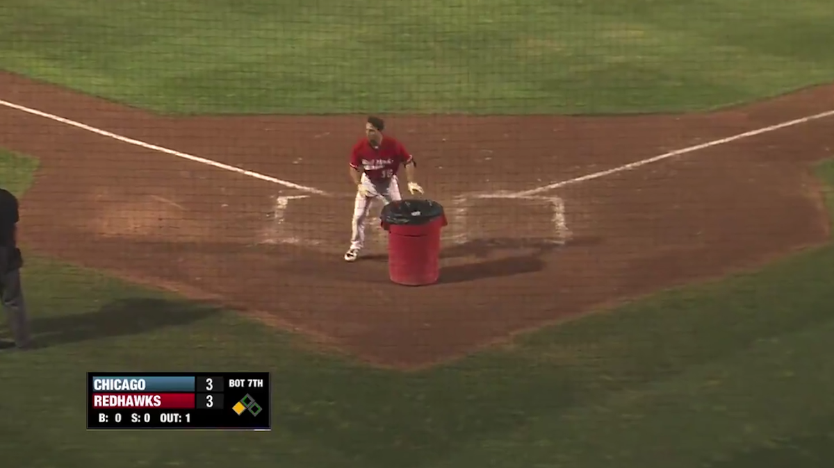 An irate baseball player put a trash can behind home plate for an umpire to jump in.