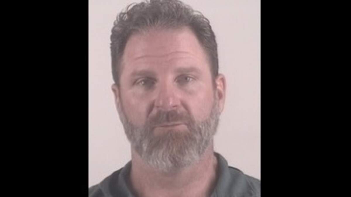 Aaron Redmond of Mansfield, accused of assaulting his wife, held police at bay for four hours from his home Friday night before he surrendered to authorities.