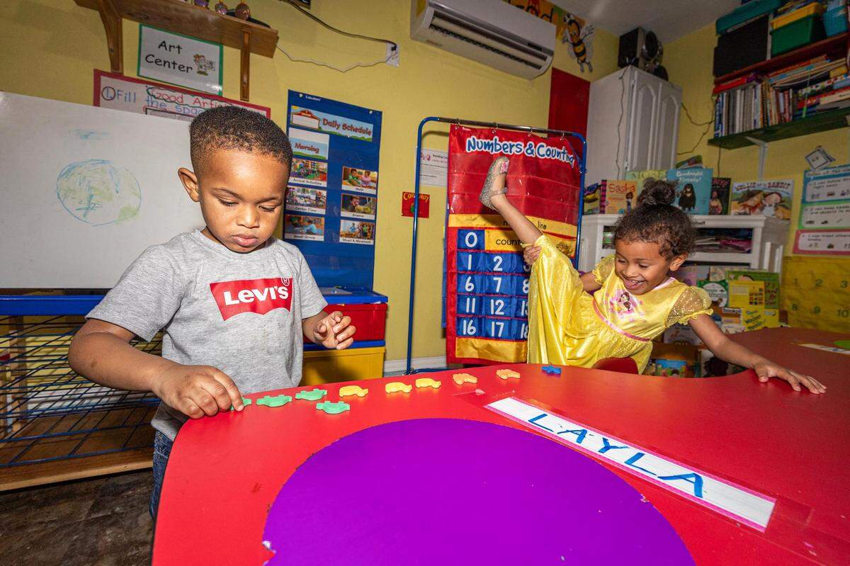 Student Tobeena Emedosi, 3, practices counting while his peer Layla Alston, 4, tests her flexibility after dinner at the Future Scholars’ Childcare and Transportation child care home in Grand Prairie on Thursday, March 14, 2024. Future Scholars’ is one of few programs in Tarrant County that provide 24/7 child care.