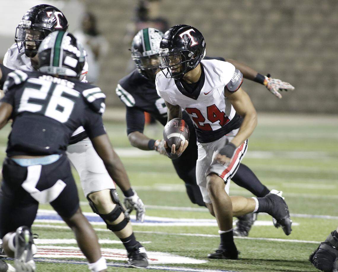 Euless Trinity running back J.T. Harris looks for running room against Mansfield Lake Ridge during their Class 6A Division I bi-district game on Friday, November 14, 2025 at Newsom Stadium in Mansfield Texas.