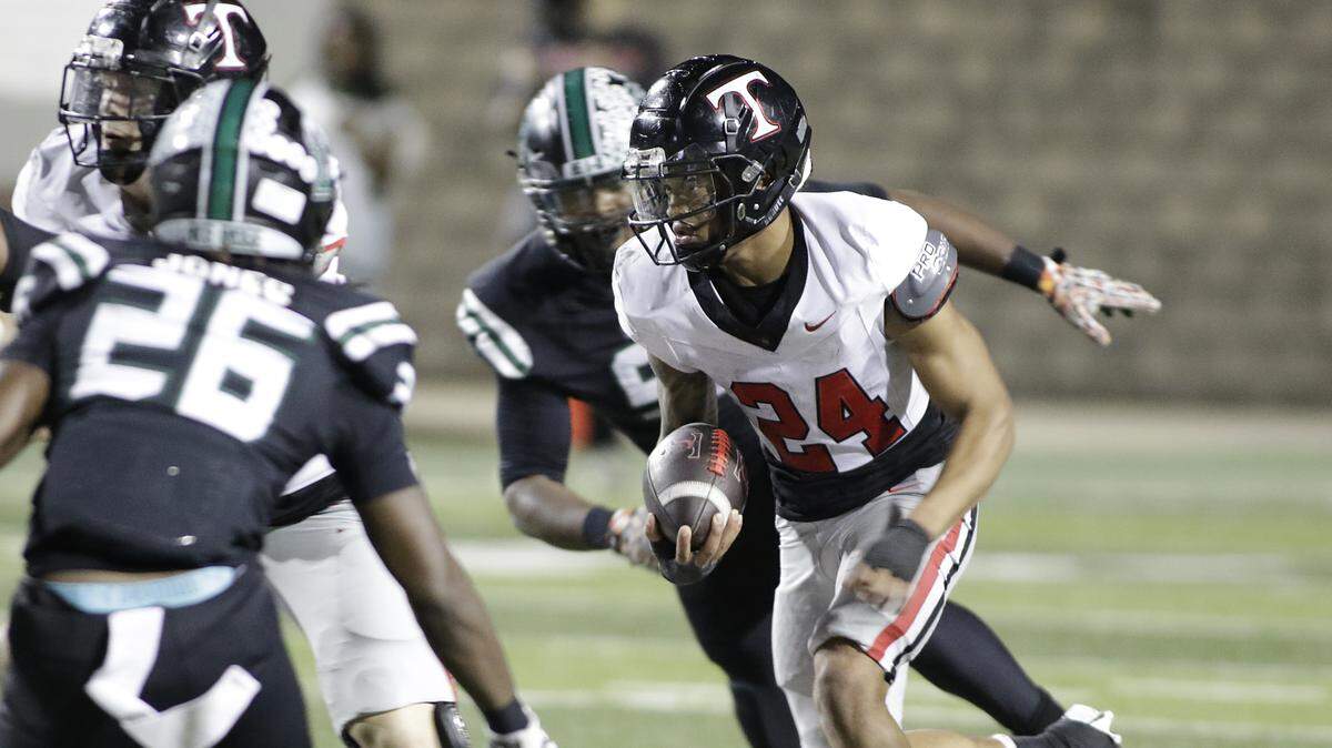 Euless Trinity running back J.T. Harris looks for running room against Mansfield Lake Ridge during their Class 6A Division I bi-district game on Friday, November 14, 2025 at Newsom Stadium in Mansfield Texas.