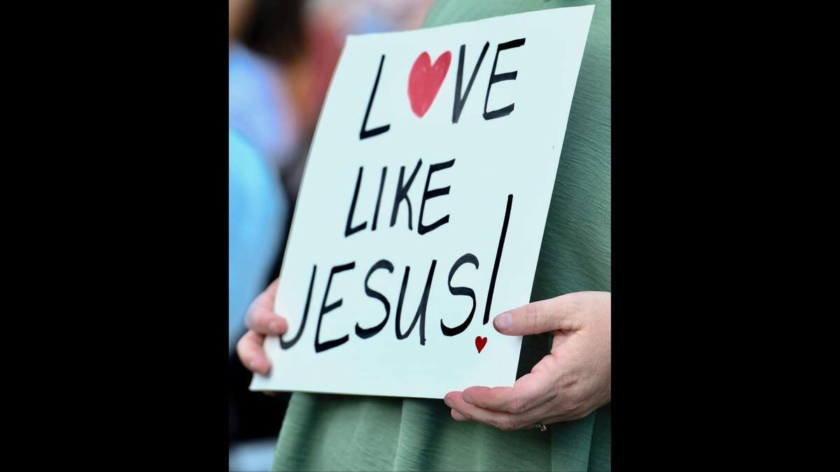 A person holds a sign Monday, Sept. 15, 2025, during a vigil held in memory of Charlie Kirk in Greenville, South Carolina.