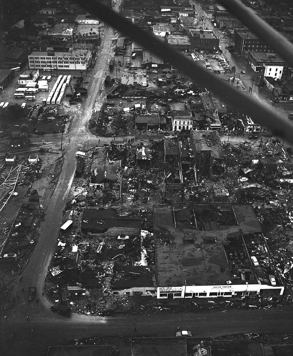 Downtown Waco after the 1953 tornado. At upper left, buses are parked at the Waco Transit Co. The road running from left to right at center of photo is the business route, U. S. Highway 81.