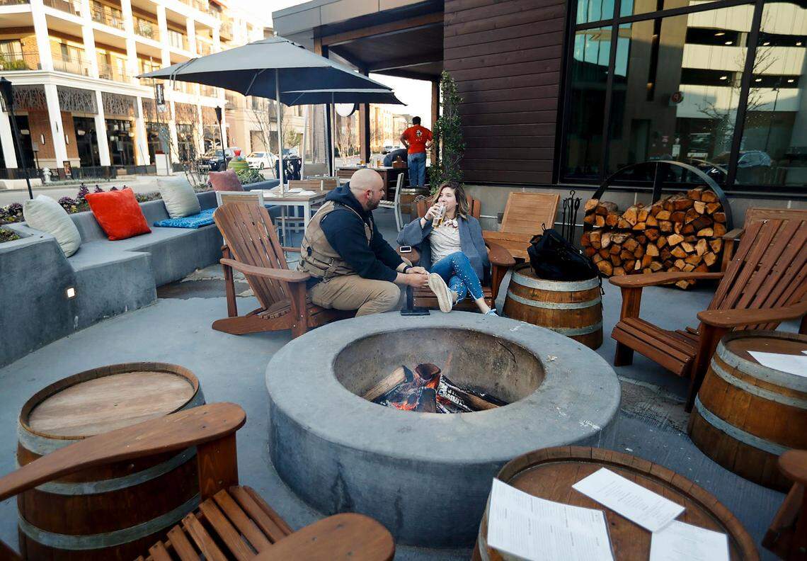 Tony Shultz, left, and Hadley Quinn enjoy an evening at the fire pit at Pinstripes on Tuesday, March 19, 2019, at The Shops at Clearfork.