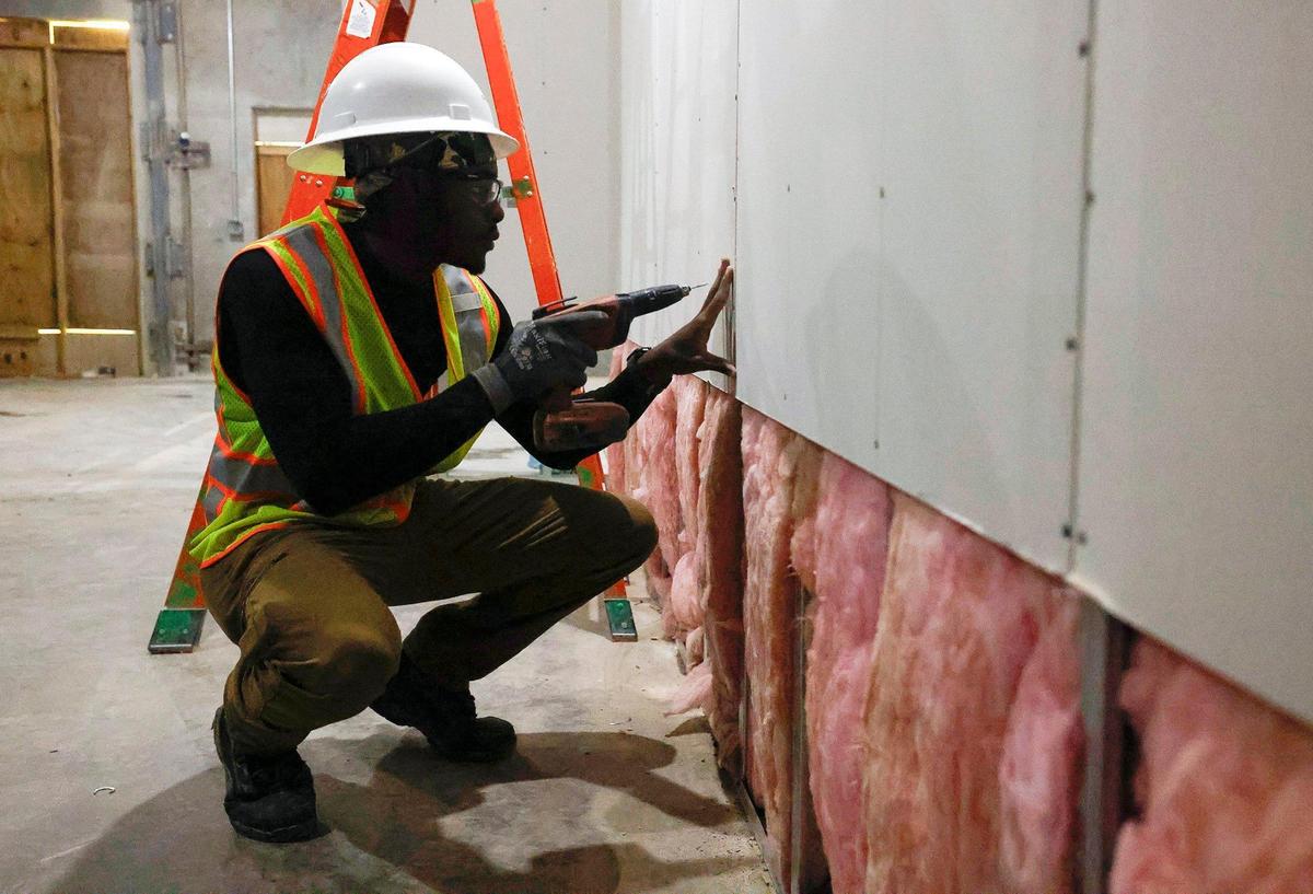 Carey Myers hangs drywall at a construction site subcontracted to Post L Group, a Black-owned business, on Friday, Nov. 17, 2023, in Fort Worth. Myers is part of the nonprofit Building Pathways, founded by Jeff Postel of Post L Group. The nonprofit works to introduce young members of the Black community to the construction industry and support their career growth within it.