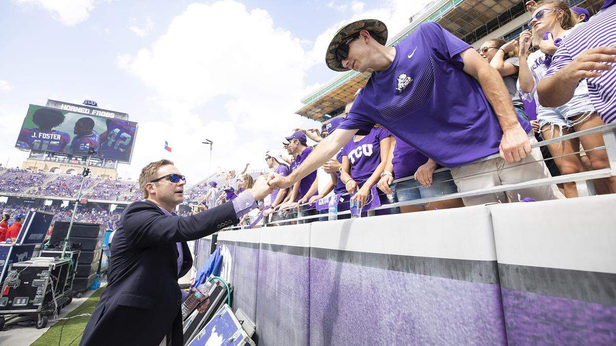 TCU athletic director Jeremiah Donati meets with fans before a football game.