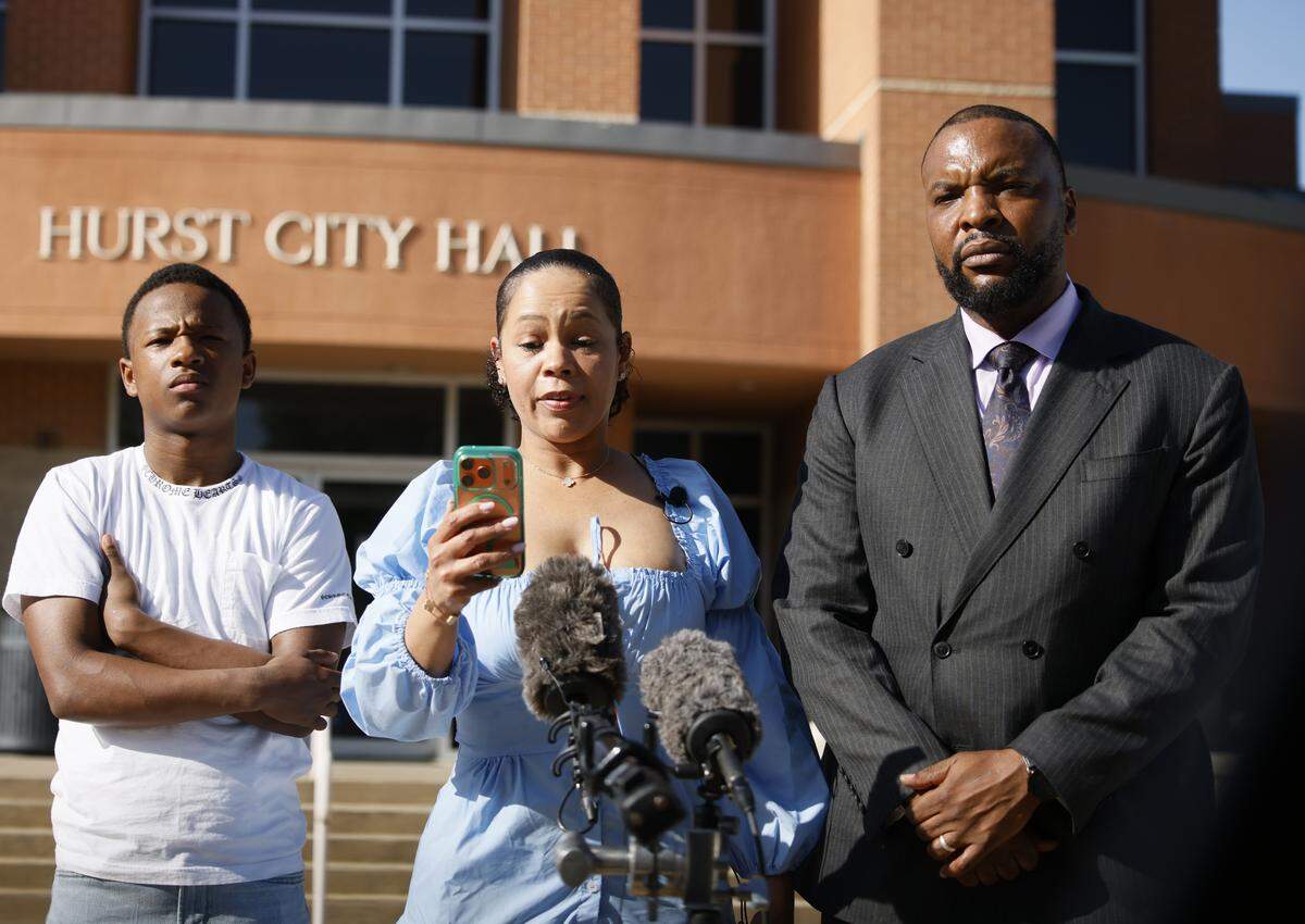 Teneisha Thompson reads a prepared statement about her traffic stop in the city of Hurst with her minor son and attorney Lee Merritt during a press conference in Hurst, Texas, Tuesday, March, 24, 2026.