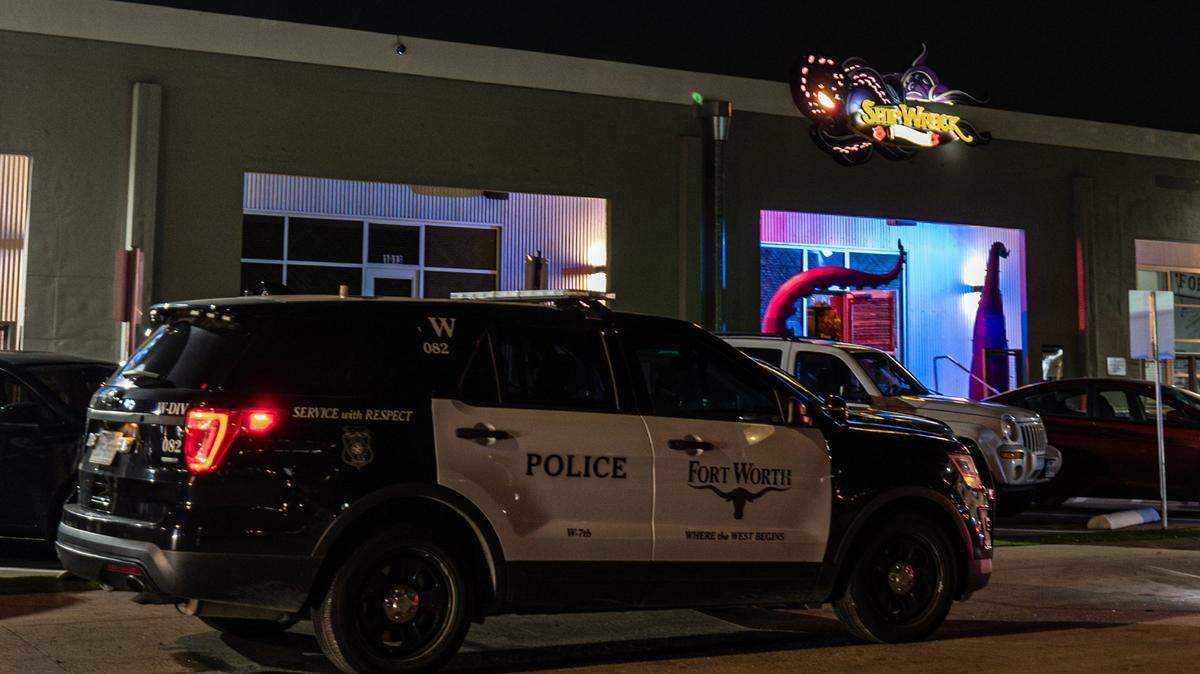 A police cruiser outside some stores