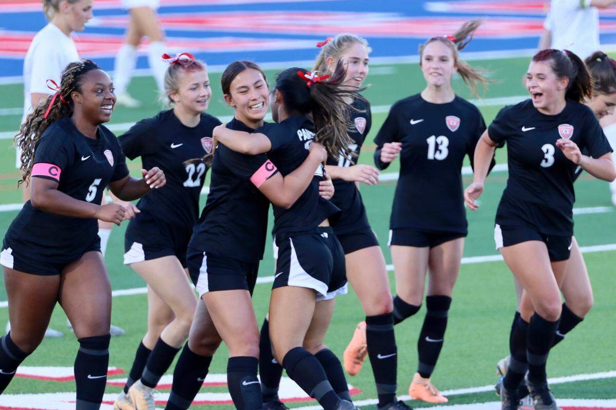 The Colleyville Heritage girls soccer team celebrates in a win during an undefeated run to the state semifinals in Georgetown, Texas.