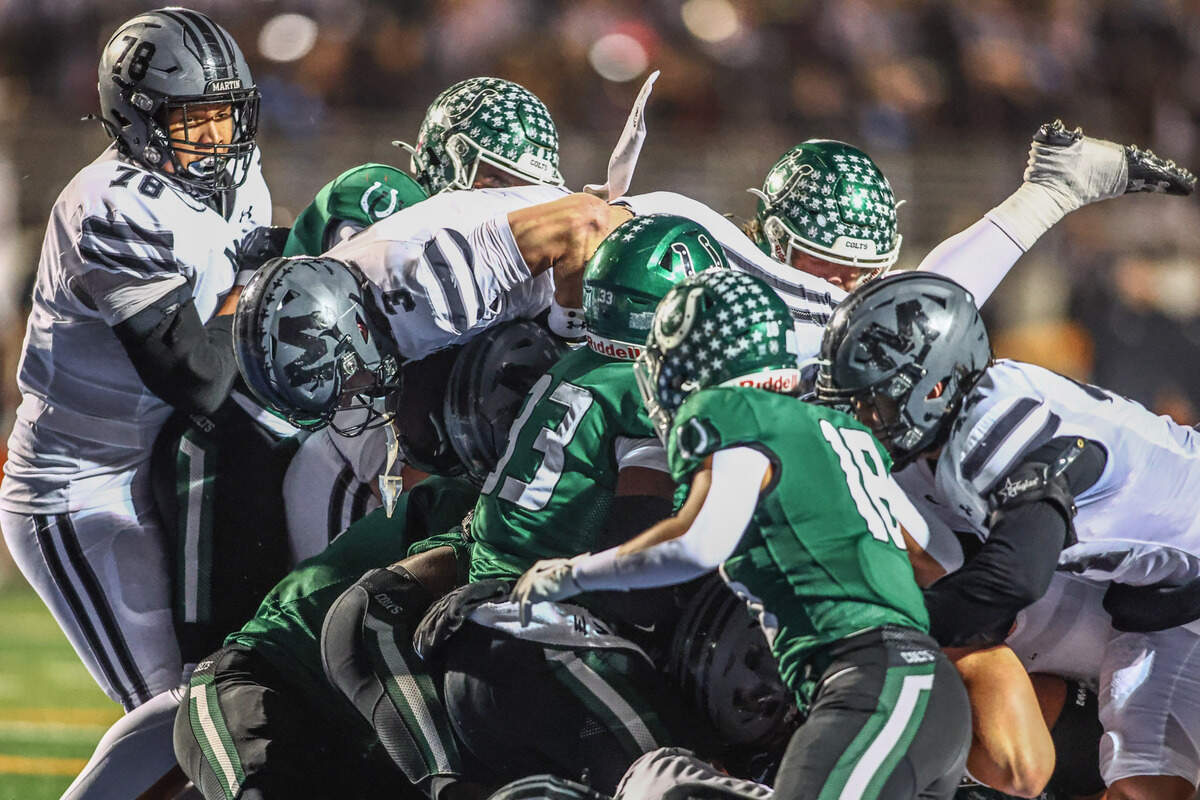 Martin’s Brooks Brigance (3) jumps over the Arlington defensive line for a short TD run in the first half of the Thursday, Nov. 7 game at UTA’s Maverick Stadium in Arlington. Special to the Star-Telegram / Tom Marvin
