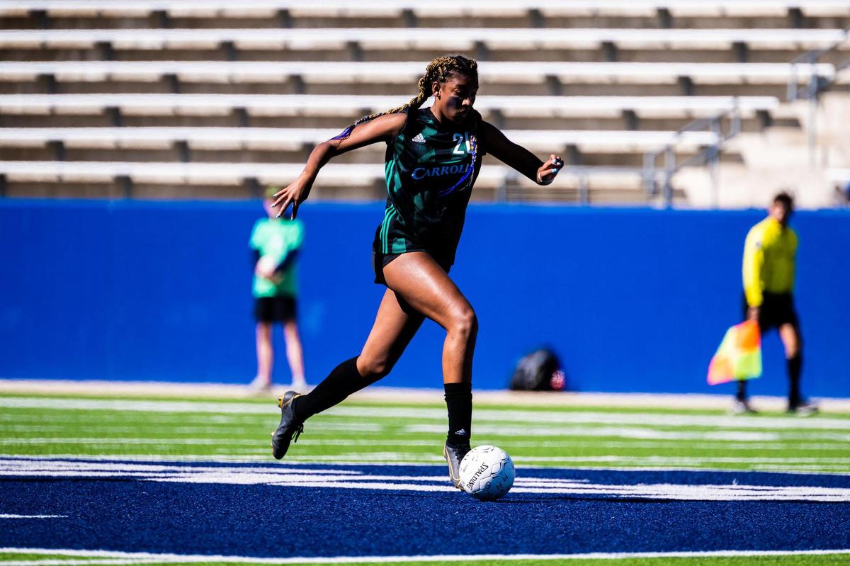 Zoe Matthews (20) runs downfield during the 6A Regional Final between the Carroll Lady Dragons and the Marcus Marauders at McKinney ISD Stadium on April 9th, 2022.