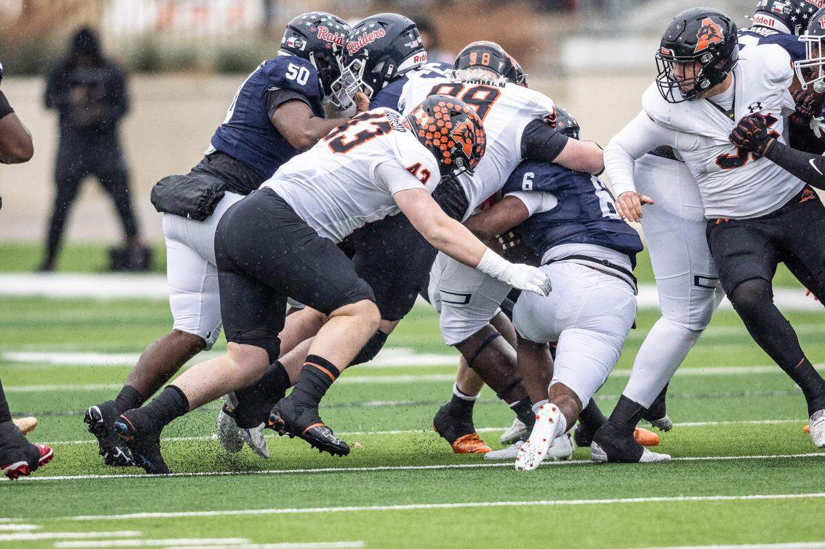 Denton Ryan running back Nemo Warmate (6) is tackled by the middle of Aledo’s defense including Talan Forman (98) and Jaxon Richter (43) in a Class 5A Division 1 state quarterfinal on Saturday, Dec. 7, 2024 at Crowley ISD Multi-Purpose Stadium in Fort Worth, Texas.