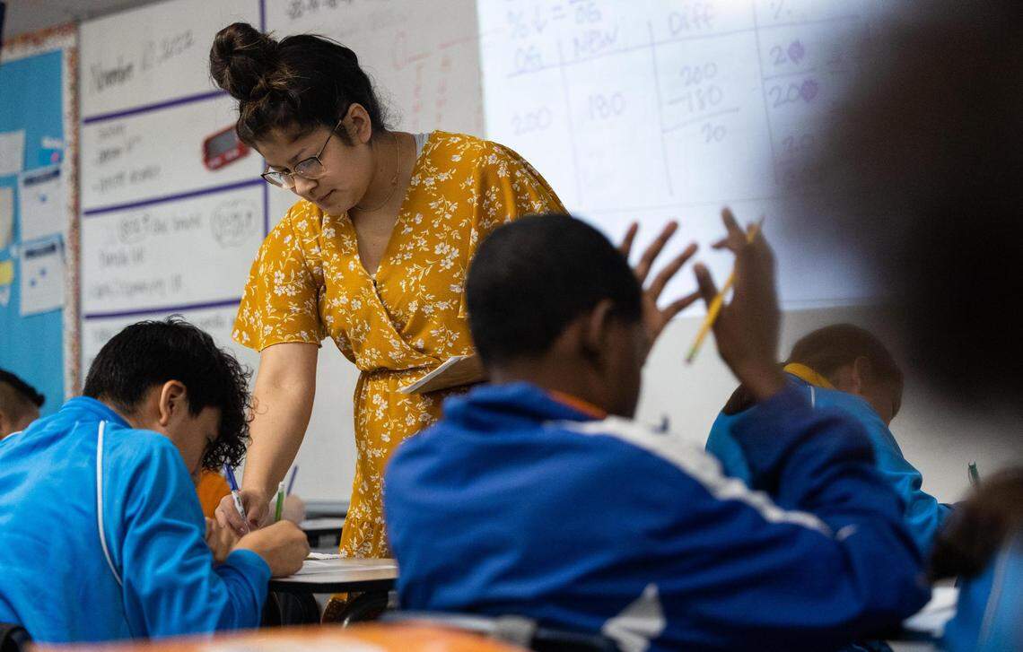 Teacher Allison Burrola checks students’ work during class at IDEA Rise school in the Las Vegas Trail neighborhood on Nov. 10, 2022, in Fort Worth.