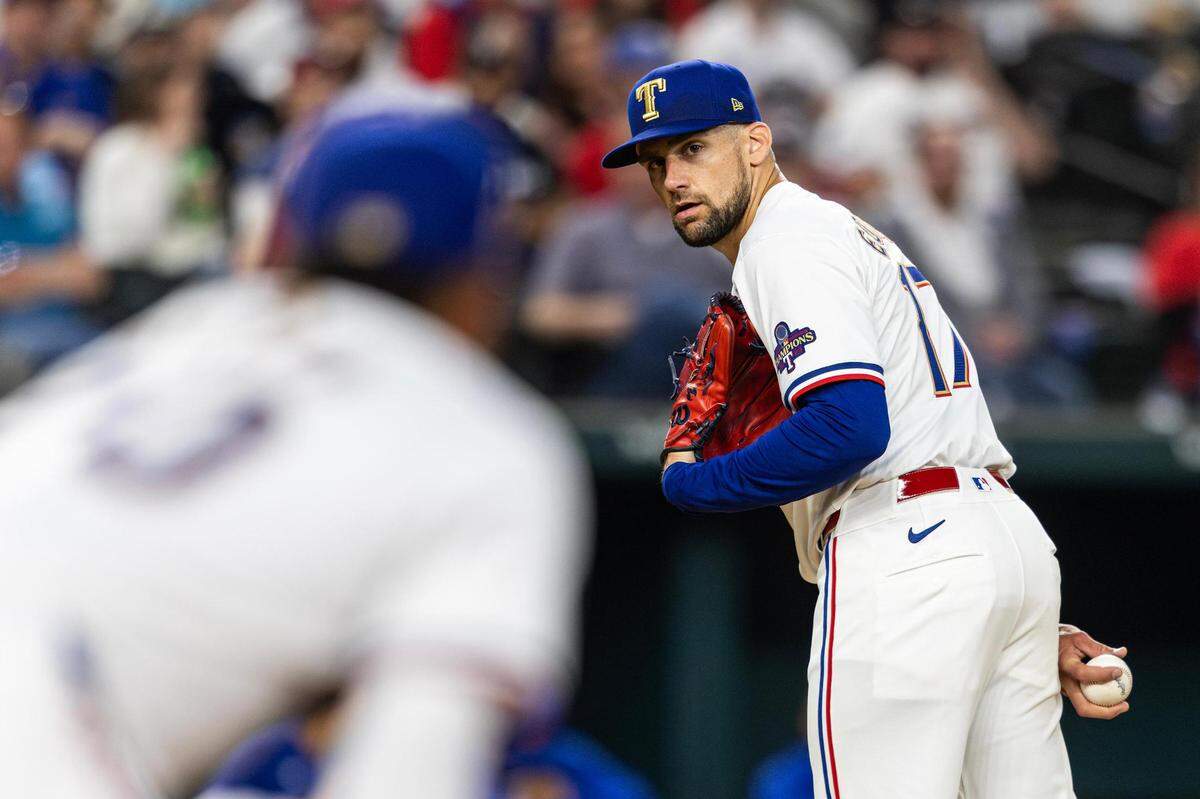 Texas Rangers pitcher Nathan Eovaldi (17) looks back at first baseman Ezequiel Duran (20) in the fifth inning of their season opener against the Chicago Cubs at Globe Life Field in Arlington on Thursday, March 28, 2024.